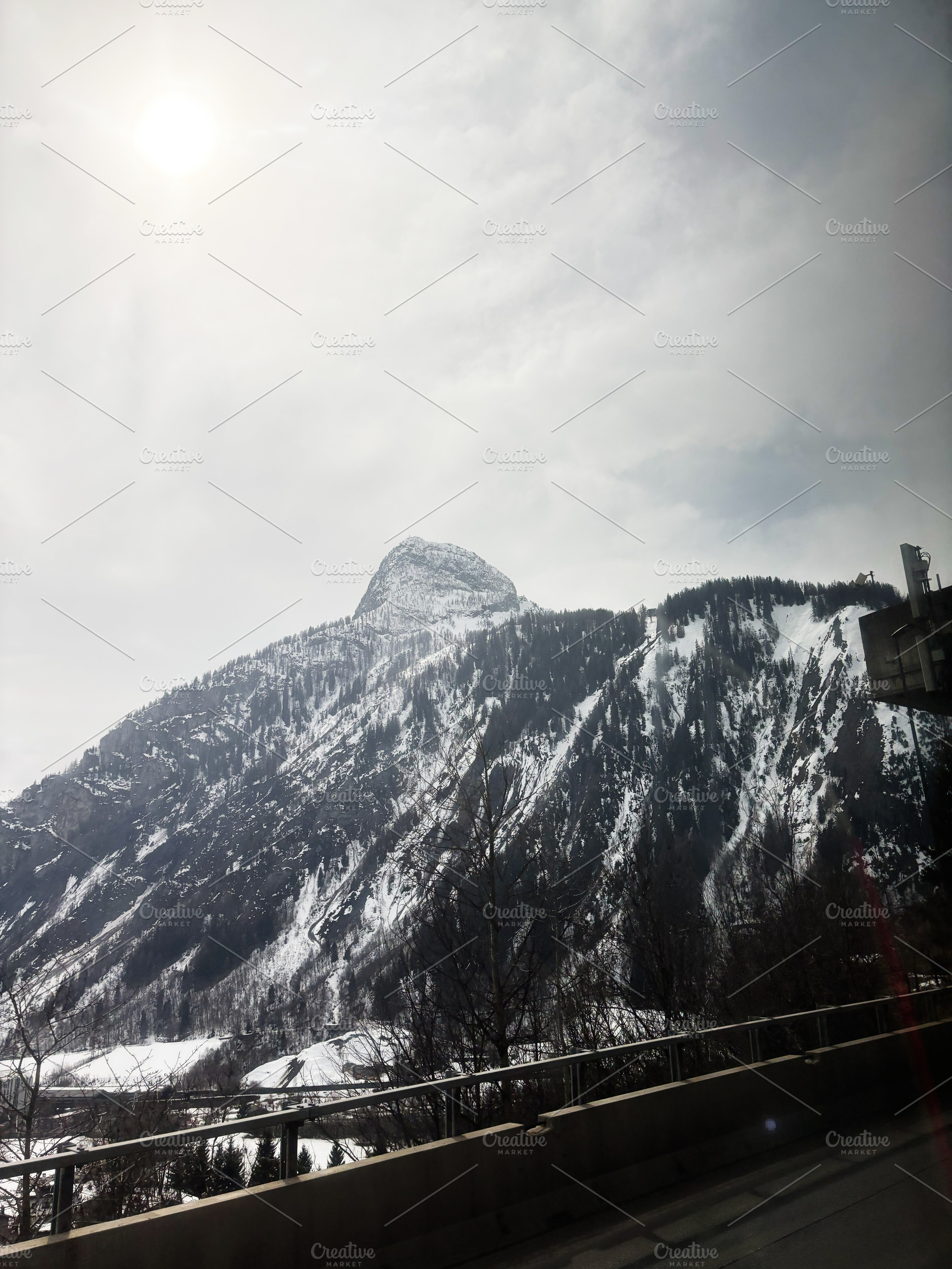 Snow-covered mountain under a cloudy sky in a picturesque winter setting Switze, a Photo by AS photostudio