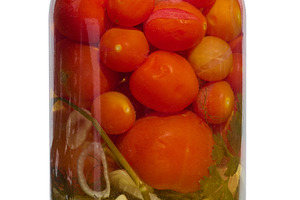 Glass jar with canned red tomatoes on isolated background, a Food & Drink Photo by ndanko