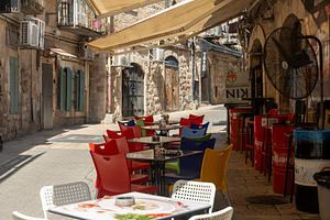 Empty outdoor cafe tables and colorf, an Architecture Photo by Imaginarium