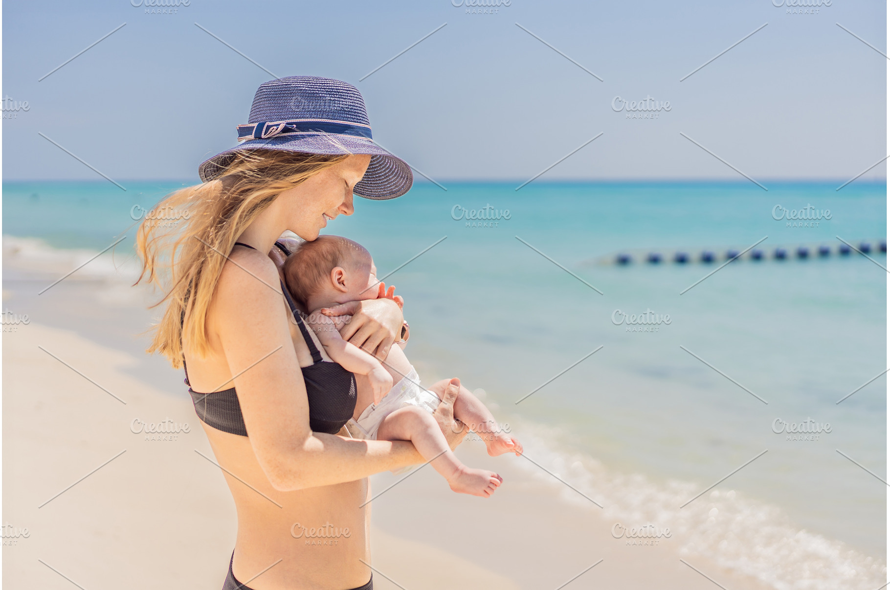 Mother holding her newborn baby by, a Person Photo by Elizaveta Galitskaya