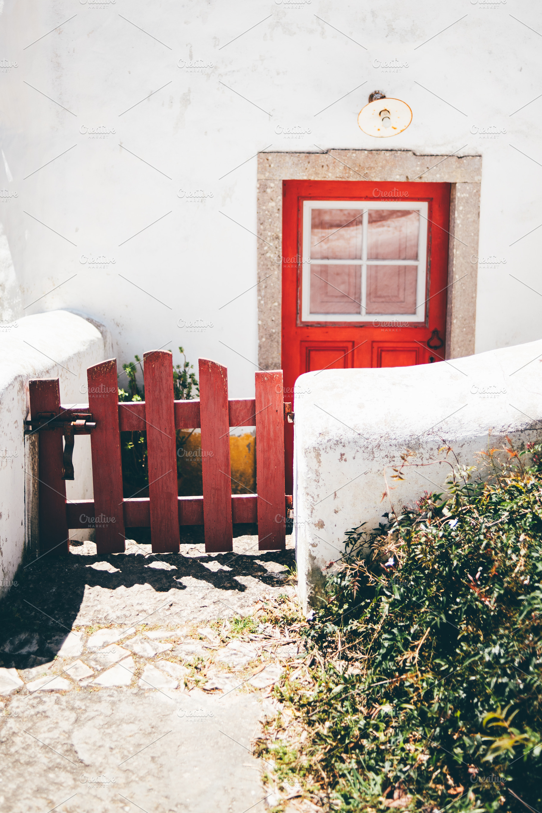 Red door and rustic white walls, an Architecture Photo by SkyNext