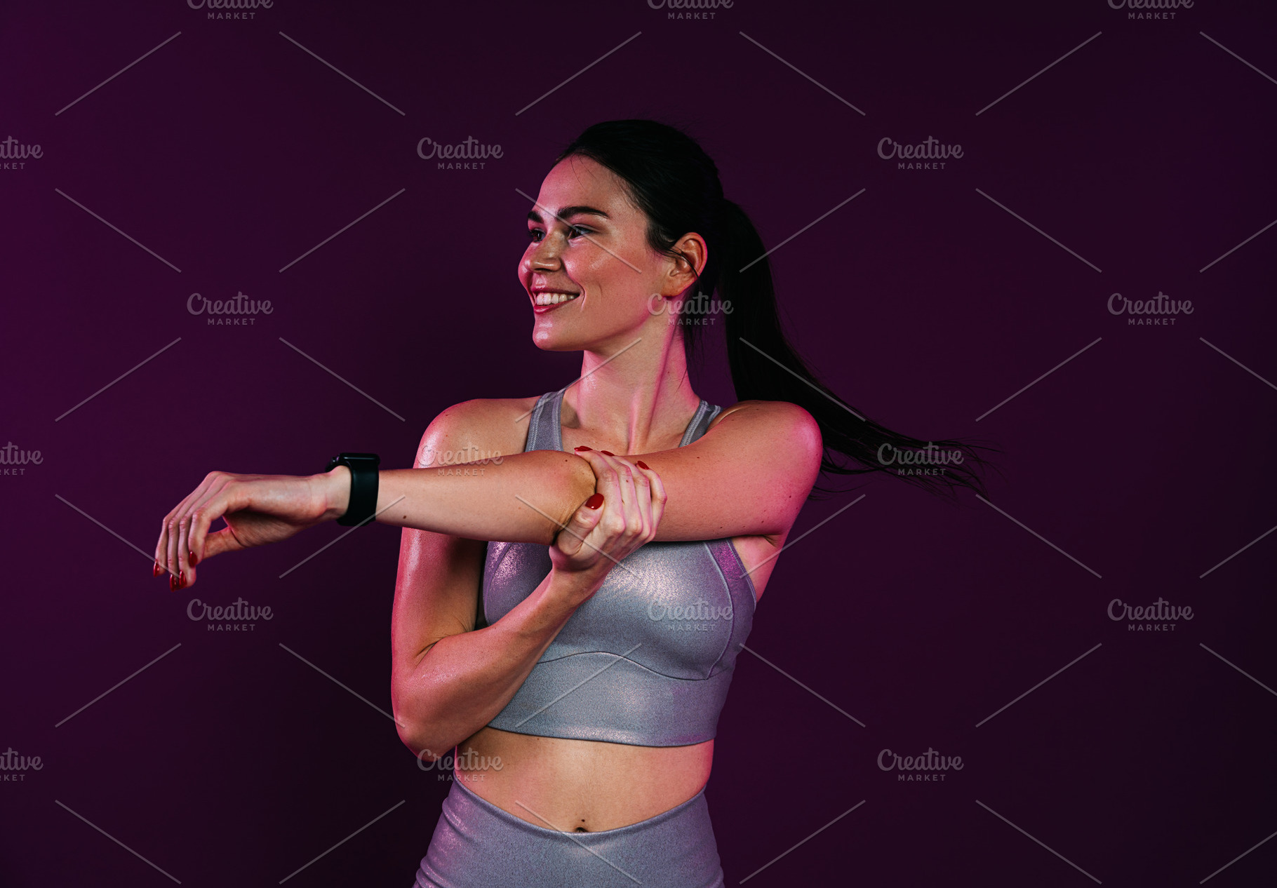 Smiling slim female flexing her hand, a Sports & Recreation Photo by Artem Varnitsin