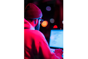 male programmer typing on laptop at, a Technology Photo by Lermont51
