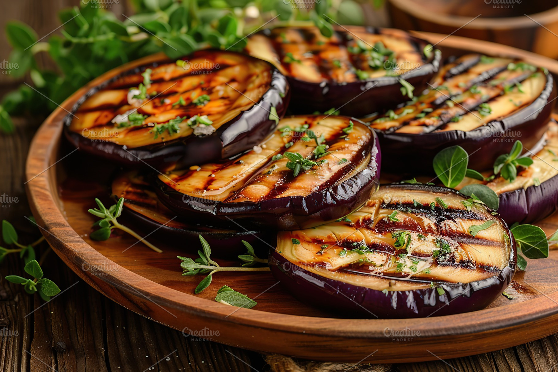 Grilled eggplants in plate on wooden table, a Food & Drink Photo by AlyaAnd