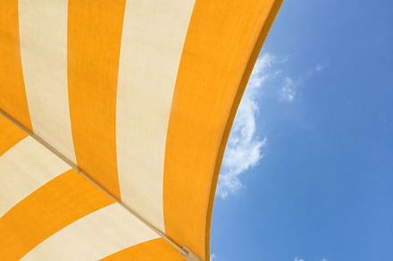 Yellow umbrella on the beach, an Abstract Photo by KYNA STUDIO