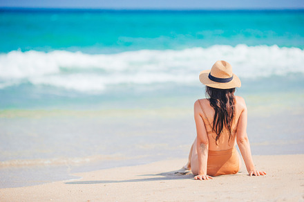 Young happy woman on the beach enjoy her summer vacation. Woman relax on the se, a Person Photo by travnikovstudio