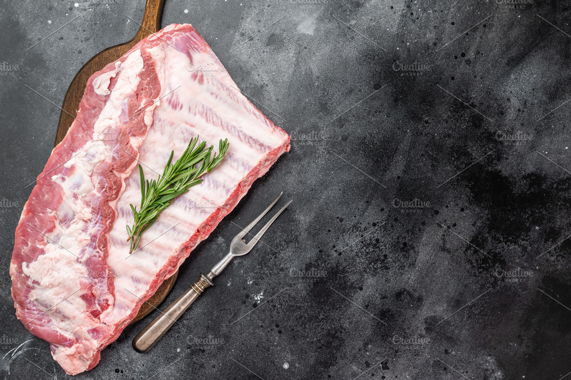 Pork spareribs raw whole rack with rosemary on cutting board ove, a Food & Drink Photo by composter-box@mail.ru