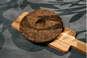Puer tea is showcased on a wooden, a Background Photo by darksoul72