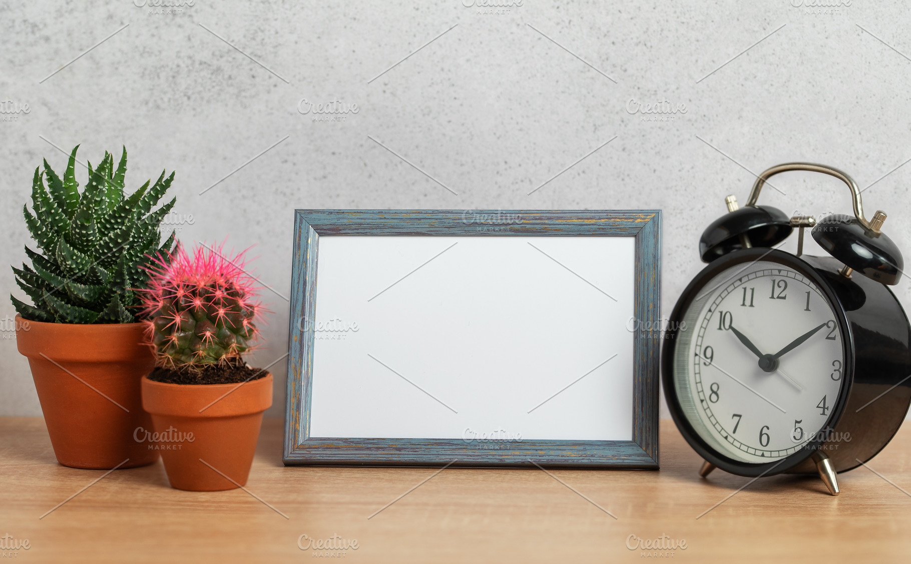 Empty frame, alarm clock and potted plants creating cozy home at, a Business Photo by Olena Rudo