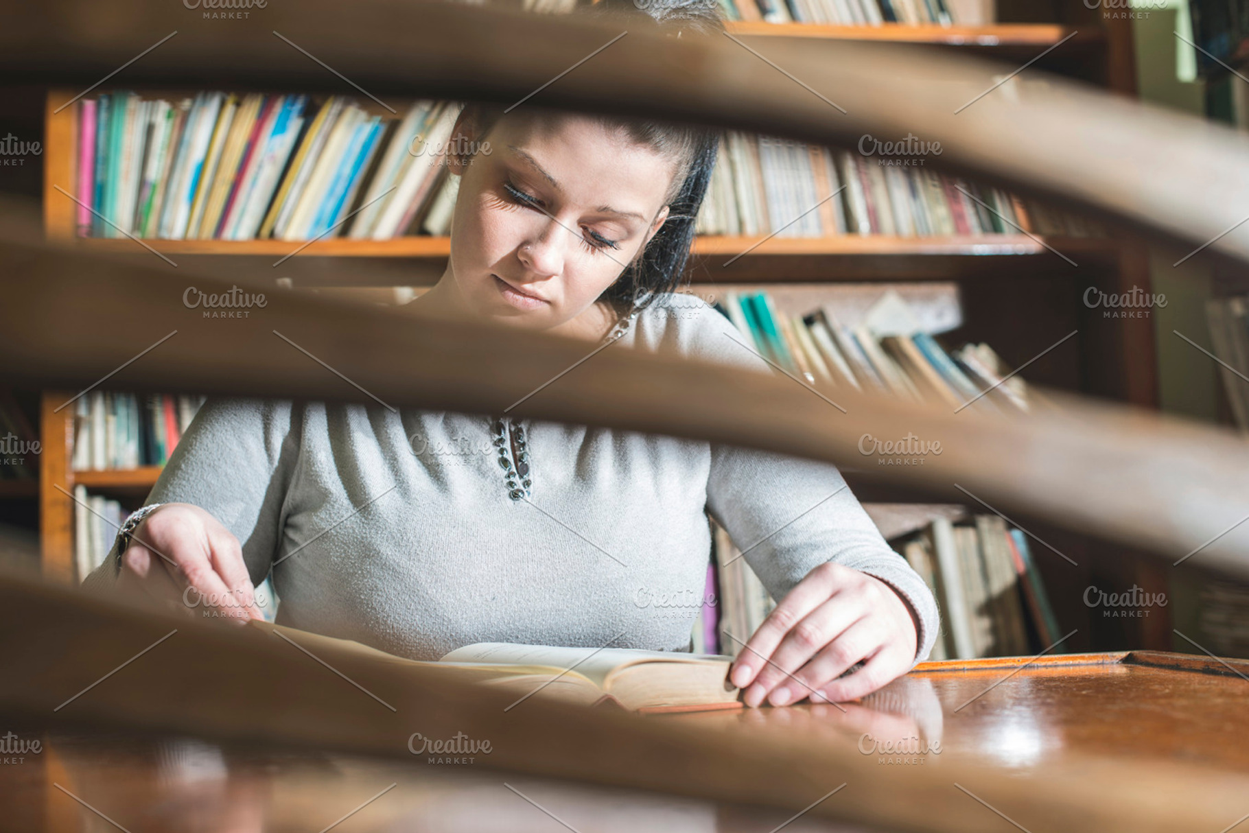 Young women in a vintage library stock photo containing library and young, a School & Education Photo by Deyan Georgiev