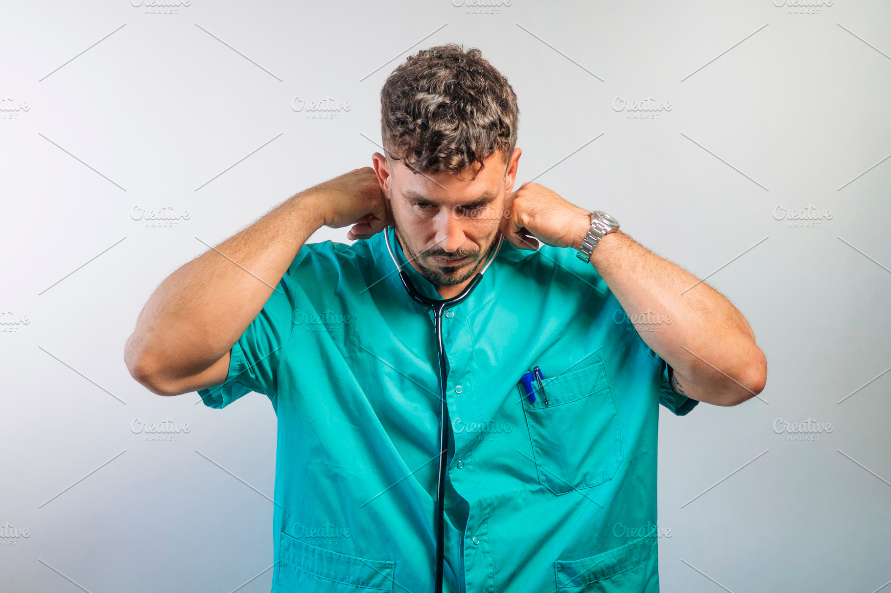 Doctor Adjusting His Stethoscope, a Person Photo by karrastock