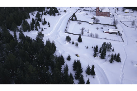 Top view of snowmobile driving along, a Nature Photo by Media Whale Stock