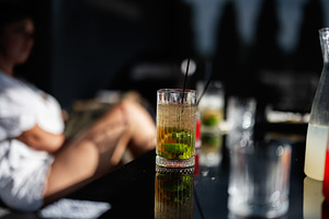 Close-up of a refreshing drink with lime in a moody outdoor setting, a Photo by AS photostudio