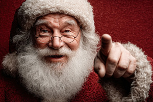 Cheerful Santa Claus with white beard smiling and pointing at ca, a Person Photo by José Manuel Gelpi