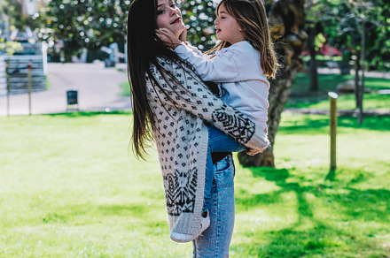 Little cute child baby hugging mom, embrace with happy pretty woman in green pa, a Person Photo by 2Design
