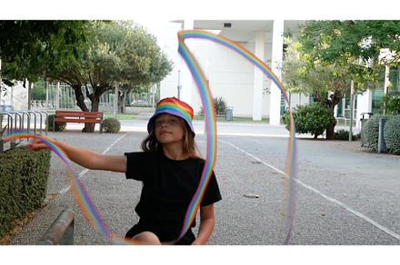 A girl and a woman in rainbow hats