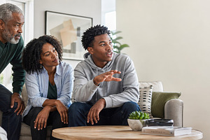 Family gathered in living room enjoy, a Photo by Dvoevnore photos