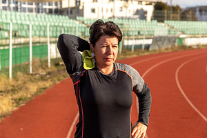 Woman wiping sweat after intense running, a Photo by Grafvision photography