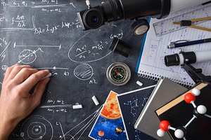 Student hand doing astronomical calculations on blackboard with, a School & Education Photo by Davizro's Market
