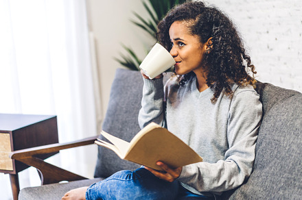 Young hipster african american black woman relaxing reading the, a Person Photo by Art_Photo