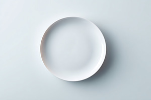 Elegant white ceramic plate on neutral background showcasing minimalist design, a Background Photo by AlyaAnd