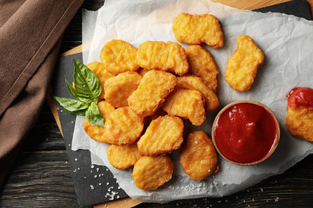 Composition with chicken nuggets and ketchup on wooden backgroun, a Food & Drink Photo by AtlasStudio