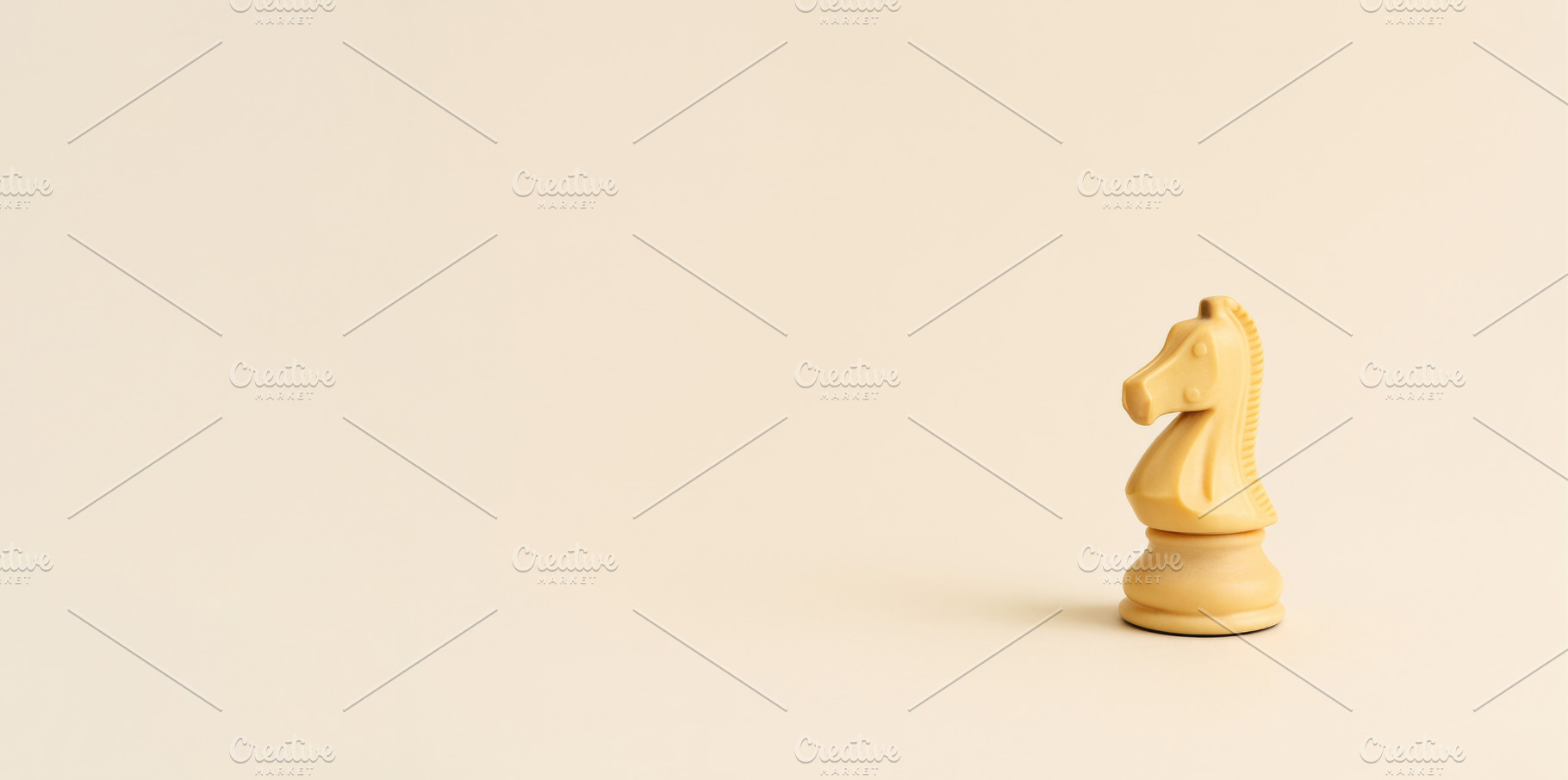 Chess knight piece on plain beige ba, a Photo by Dvoevnore photos