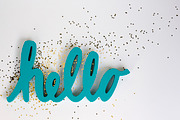 Teal Hello + Gold Sparkles Flatlay, a Business Photo by Andrea Schrag Designs (Thumbnail 1 of 2)