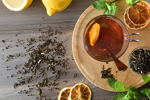 Black tea with lemon and mint on wooden table top, a Food & Drink Photo by Davizro's Market
