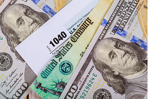 1040 Tax form with refund check and, a Business Photo by Ungvar Studio