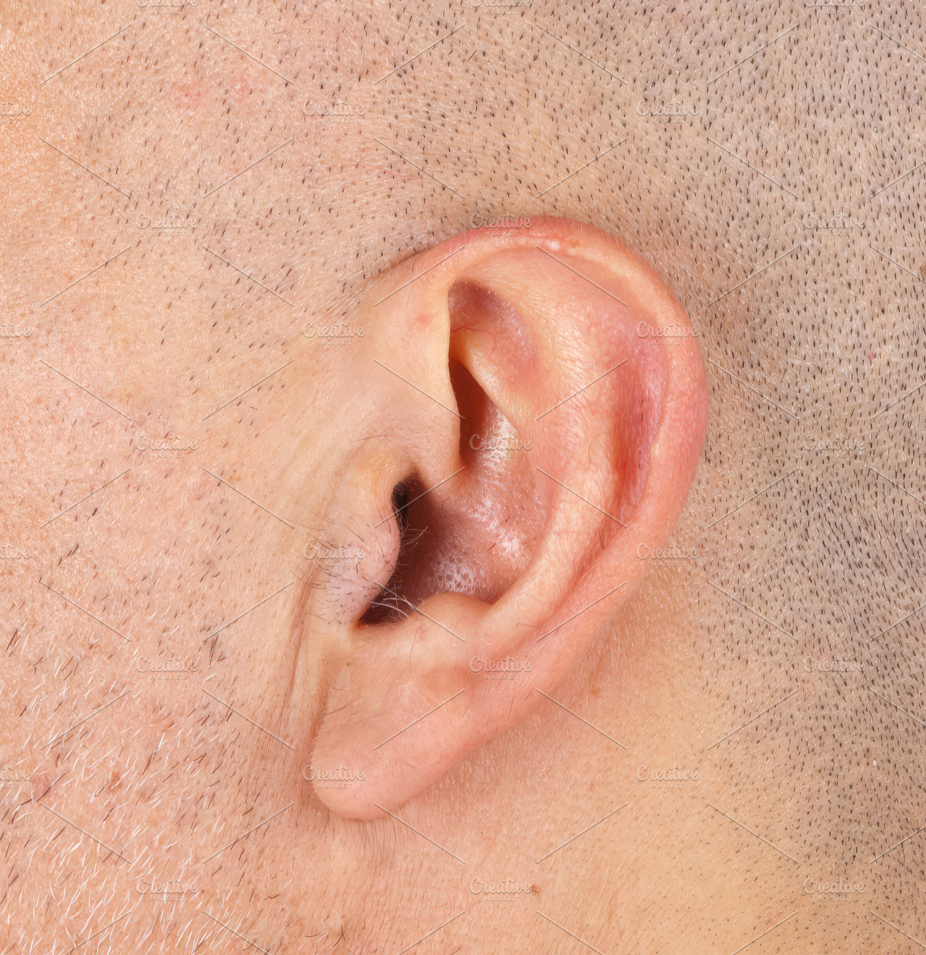 Close-up of a man's ear showing hair growing inside and outside it, an Abstract Photo by Antonio Gravante Market