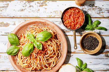 Cooked spaghetti bolognese containing above, appetizing, and basil