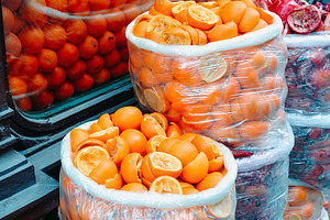 plastic bags filled with squeezed orange halves