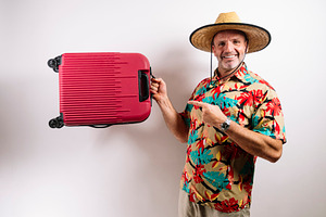 Man ready for vacation with red suitcase, a Person Photo by karrastock
