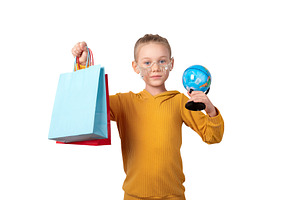 Smiling girl in yellow sweater holding colorful shopping bags an, a Person Photo by Ales Munt