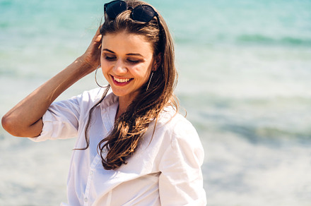 Portrait of smiling fashion woman relaxation on the tropical bea, a Person Photo by Art_Photo