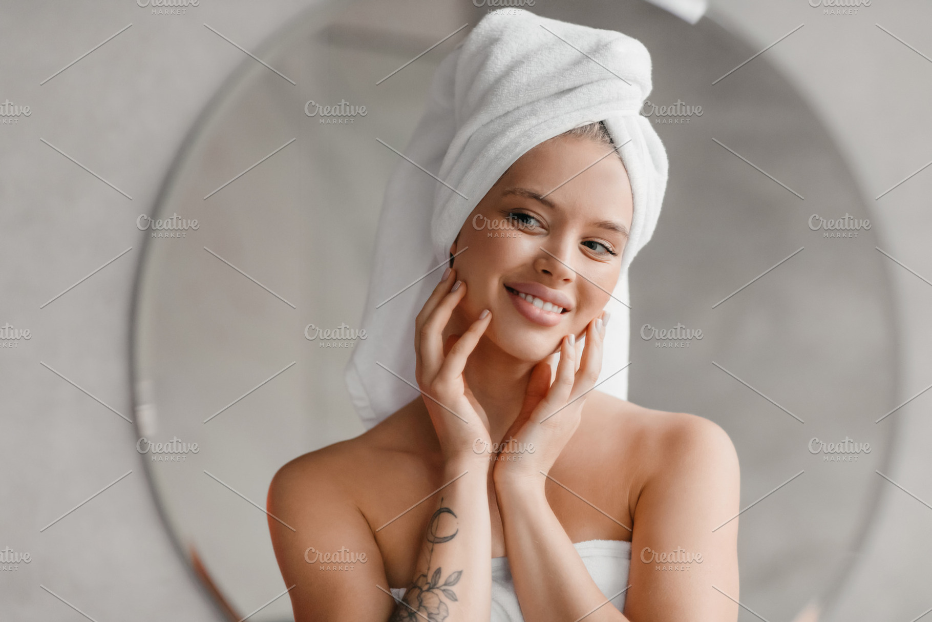 Self care day. Pretty lady wrapped in towels looking at mirror in bathroom, doi, a Photo by Prostock-Studio