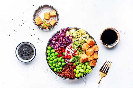 Healthy vegan food. Buddha bowl with quinoa, fried tofu, avocado, a Food & Drink Photo by 5PH