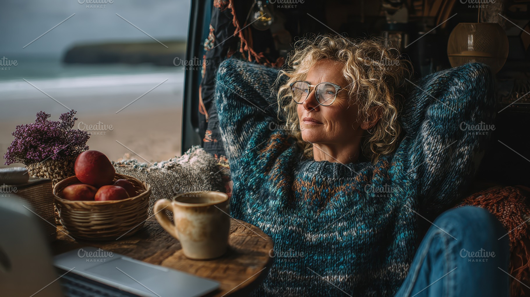 Woman relaxing in van by ocean beach, a Photo by Pixeness Studio