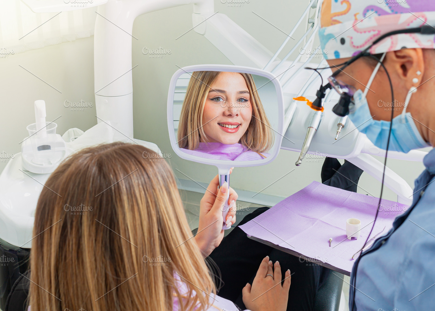 Young woman admiring her smile after dental procedure, a Health & Medical Photo by Antonio Gravante Market
