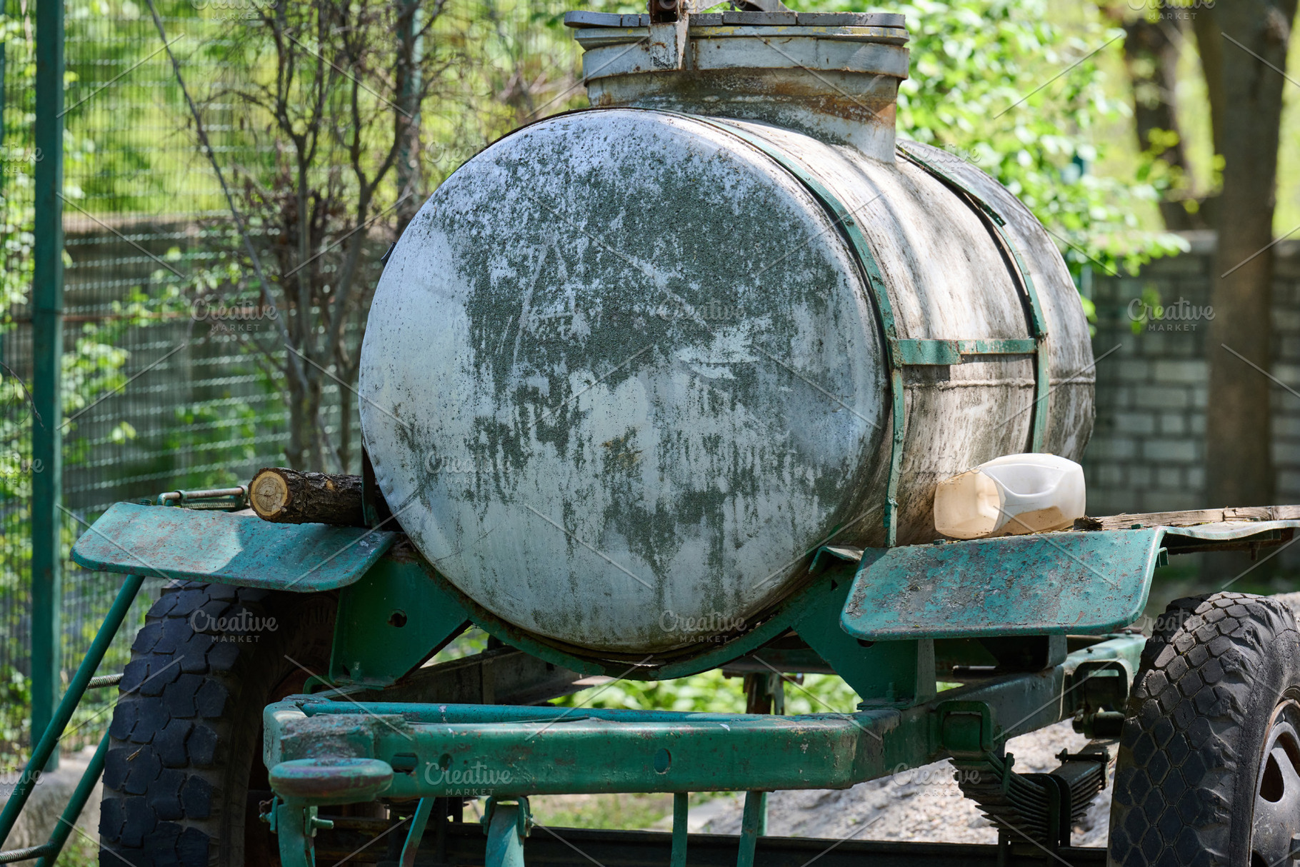 An old metal tank on a trailer, covered with traces of rust and, a Transportation Photo by ndanko
