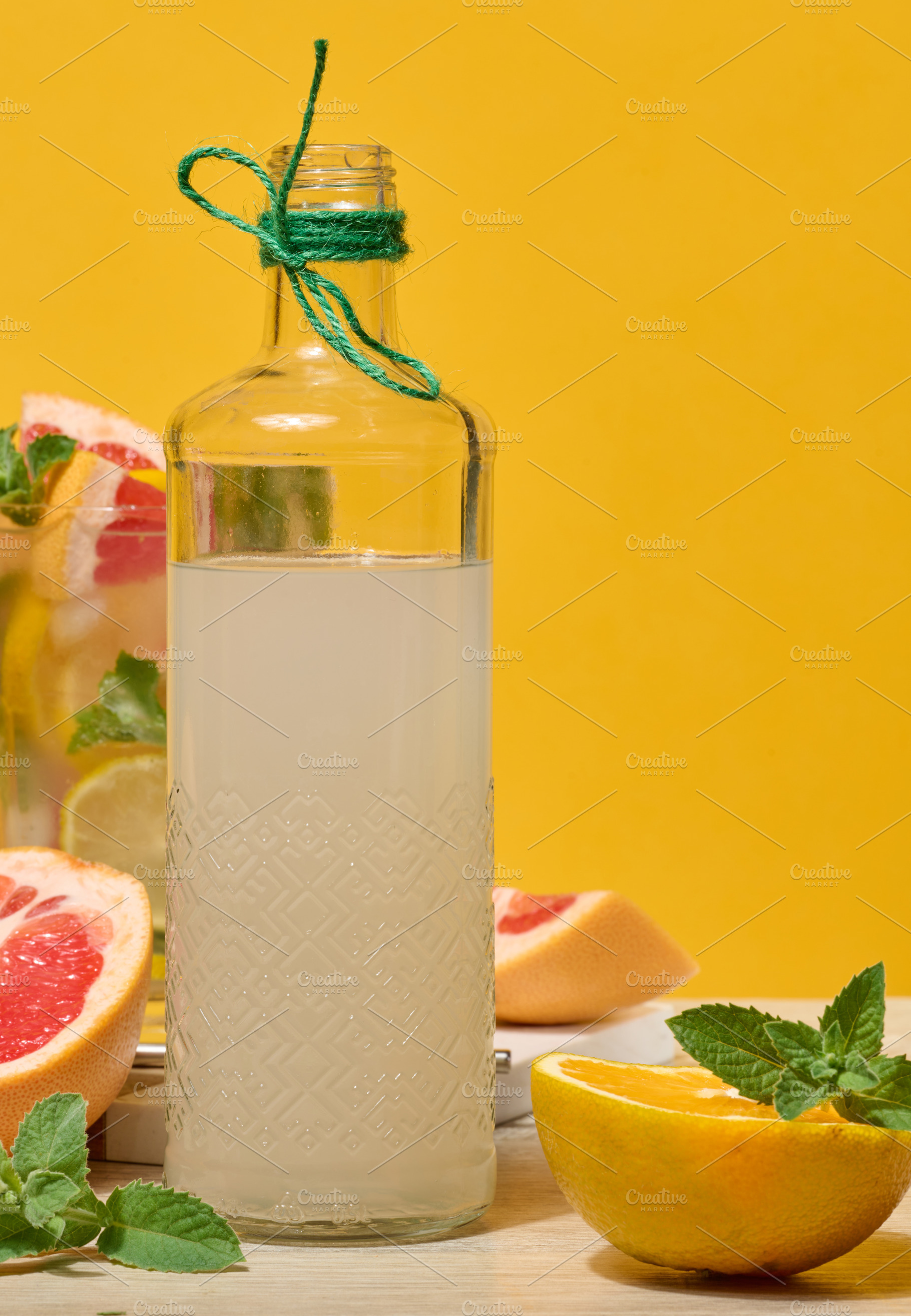 Fresh citrus drink with lemon, grapefruit, and mint in a glass w, a Food & Drink Photo by ndanko