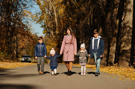 Mother with four kids in autumn park. Family walk in fall forest, a Person Photo by AS photostudio