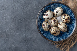 Fresh quail eggs are presented on a, a Food & Drink Photo by ZinetroN