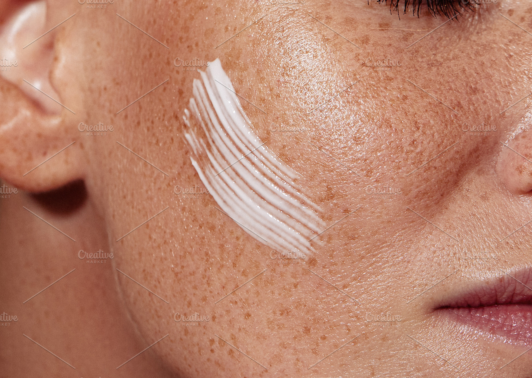 Freckled female skin with a cream, a Person Photo by Artem Varnitsin