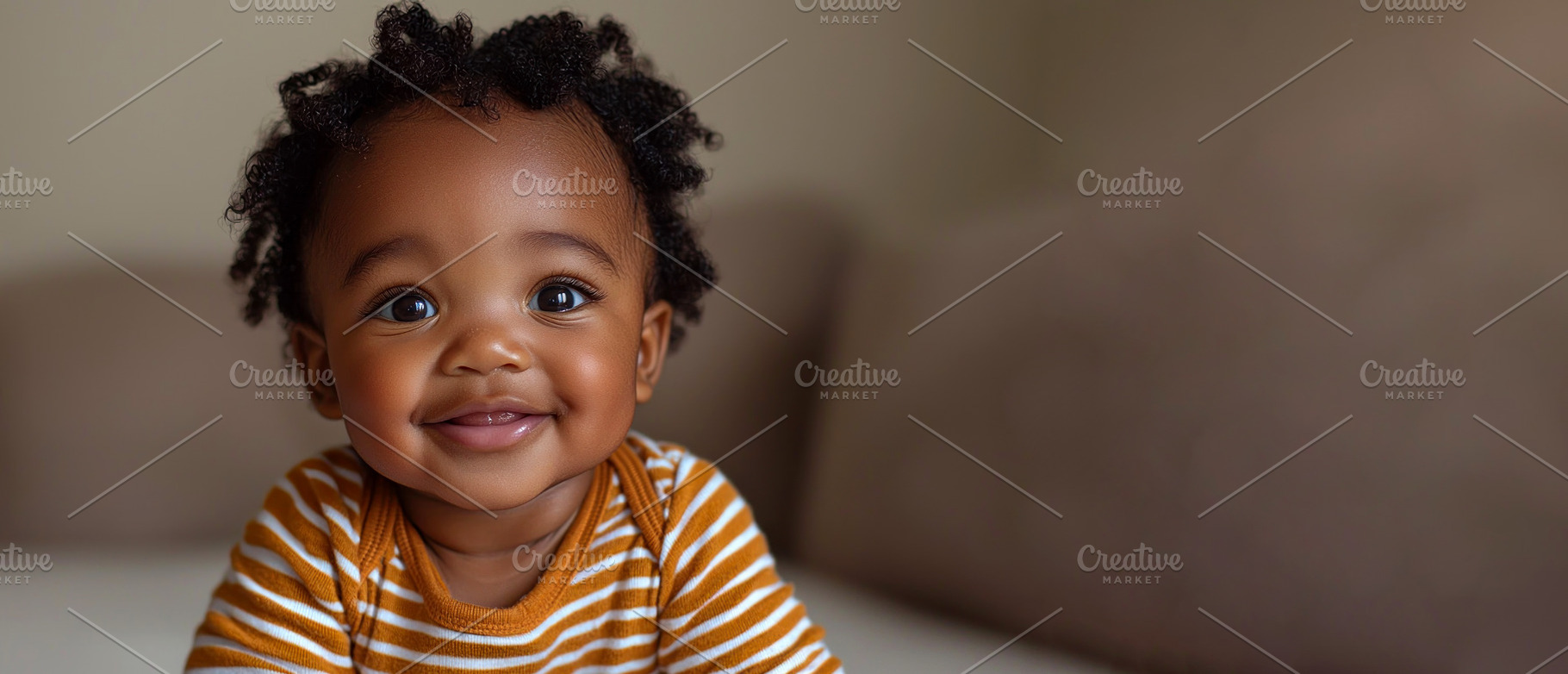 Happy baby with curly hair in orange striped shirt smiling while, a Person Photo by José Manuel Gelpi