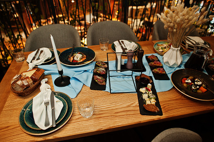 Beautifully laid tables with food, glasses and appliances in res, a Food & Drink Photo by AS photostudio