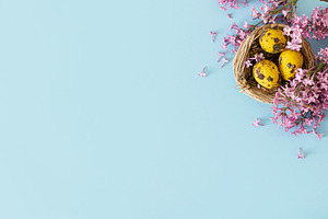 Easter flat lay. Stylish easter eggs in nest and lilac flowers o, a Holiday Photo by Sonjachni