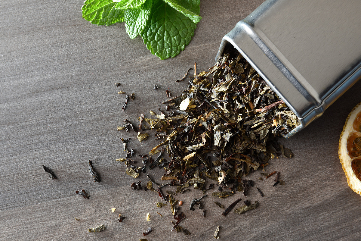 Wooden spoon filled with tea leaves on background of tea, a Food & Drink Photo by Davizro's Market (Photo 1 of 2)