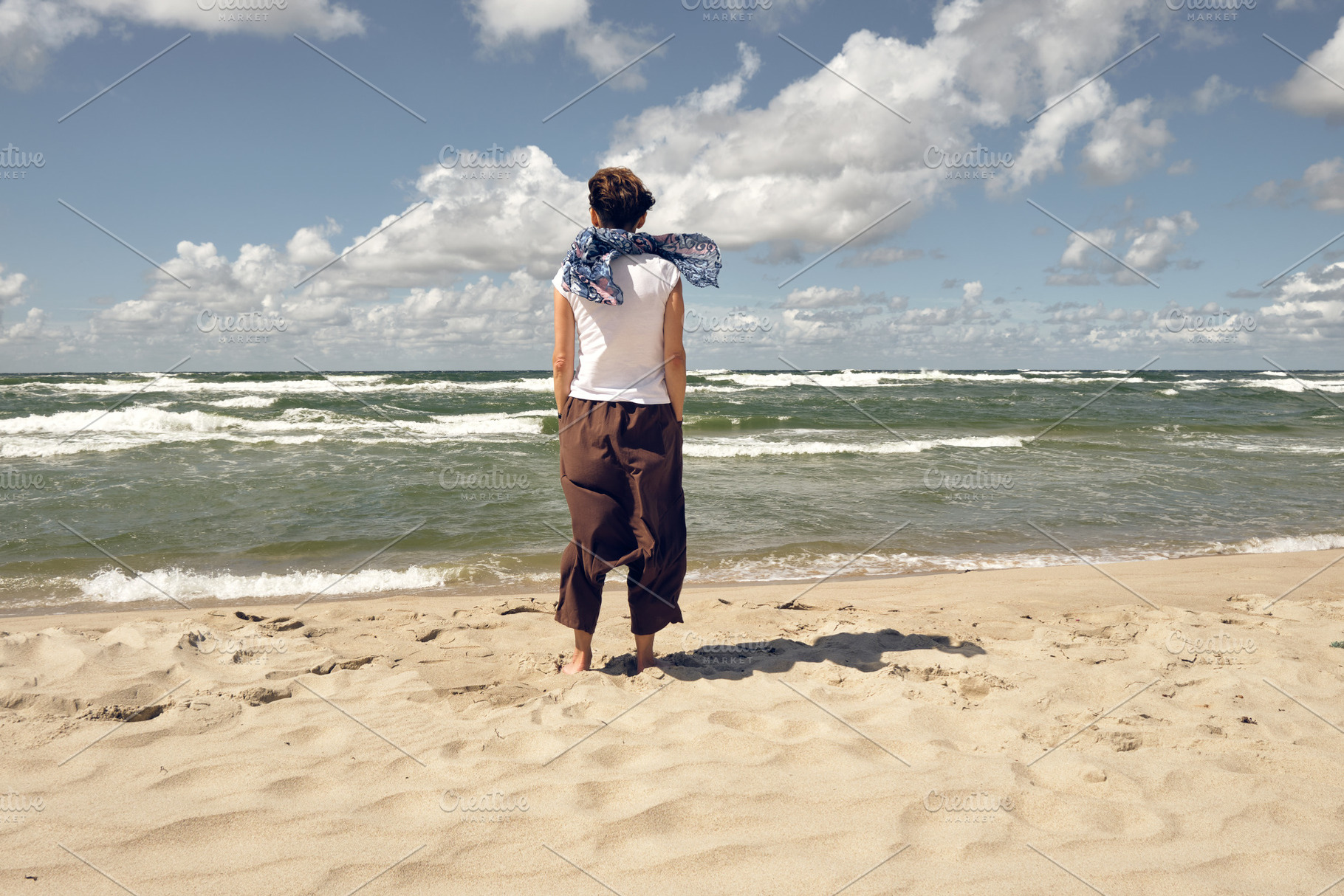 Rear view of woman on the beach, a Person Photo by BOOCYS